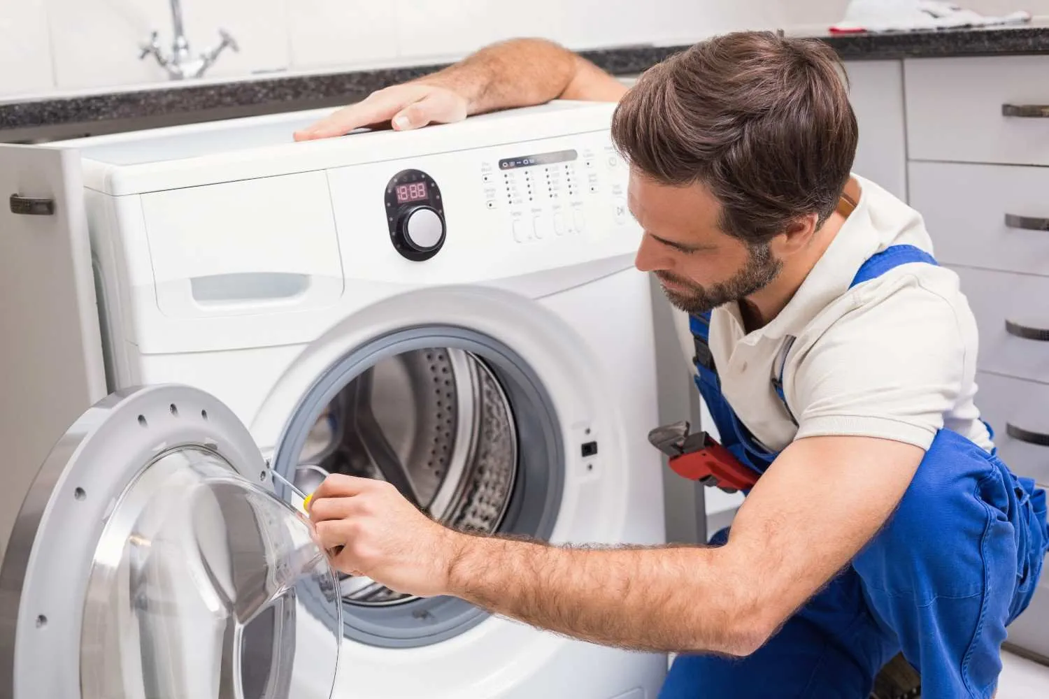 Technician checking a front-load washing machine